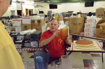 Bill Poss of Aurora shows some of the items he will auction off during the Luigi's Pizza and Fun Center online auction July 26-27.  The iconic Aurora establishment closed after 41 years in business.  Photo by Al Benson