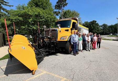 Members of the Kane County Transportation Committee in front of one of the six new snow plow trucks purchased by KDOT