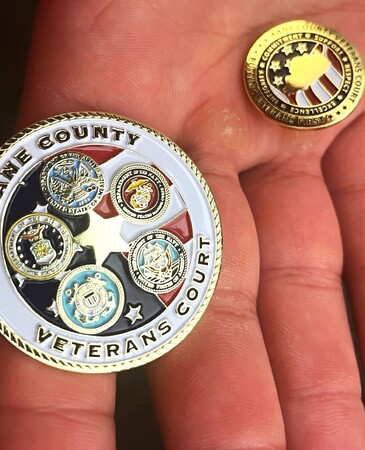 The two graduates were given a challenge coin and a pin.