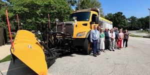 Members of the Kane County Transportation Committee in front of one of the six new snow plow trucks purchased by KDOT