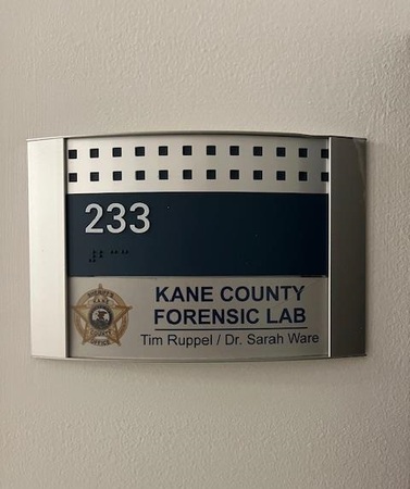 Door placard outside the New Kane County Forensic Lab