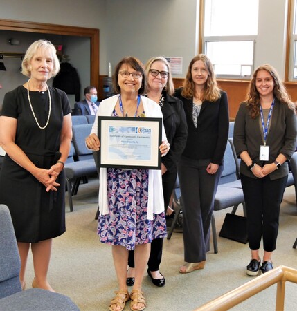 Kane County Board Member Mavis Bates, chair of the Board's Energy and Environmental Committee, holds the EPA Green Power certificate during this week's Board meeting. 