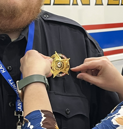 Badge Given to Newly Sworn in KCOEM Volunteer Officer 