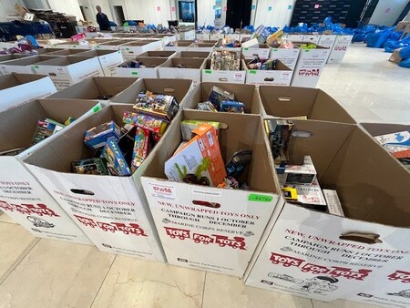 Boxes by the dozens are collected an sorted to make sure the right toy reaches the right child