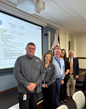 Members of KaneComm and County Board members Bill Roth and Bill Lenert 