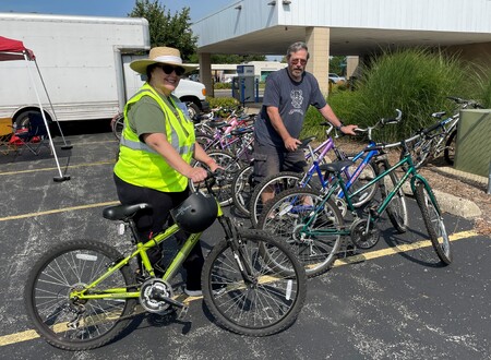 Volunteers from Hesed House showcase some of the bicycles collected during the event