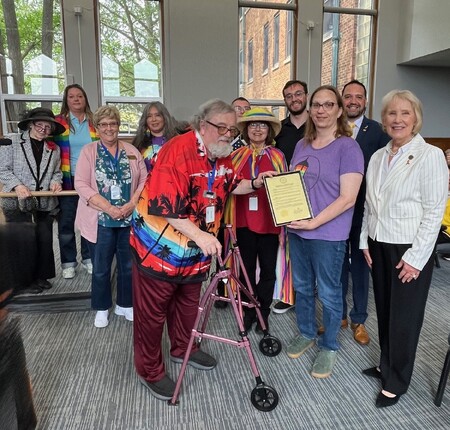 Kane County Board member Michael Linder presents the 2025 Pride Month proclamation to Gwyn Ciesla, President of Aurora Pride