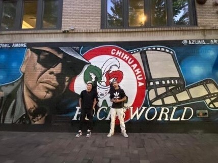 Javier Azuna and  Joel Feliciano in front of the mural dedicated to Rocky Lopez