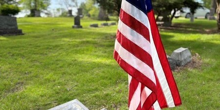 Flag posted at grave of fallen solider from Geneva Township