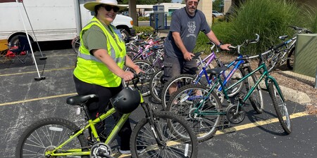 Volunteers from Hesed House showcase some of the bicycles collected during the event