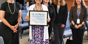 Kane County Board Member Mavis Bates, chair of the Board's Energy and Environmental Committee, holds the EPA Green Power certificate during this week's Board meeting. 