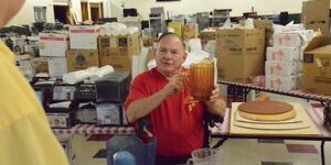 Bill Poss of Aurora shows some of the items he will auction off during the Luigi's Pizza and Fun Center online auction July 26-27.  The iconic Aurora establishment closed after 41 years in business.  Photo by Al Benson