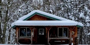 A cabin in the Northwoods, amid a mixed conifer-hardwood forest, is the perfect place to attempt a variety of retirement pursuits. At the top of Pam’s list: Get snowed in. Photo Credit to Joni Kupar