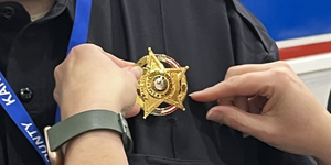 Badge Given to Newly Sworn in KCOEM Volunteer Officer 