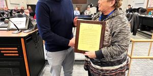 Robert Desio of the Northern Illinois Food Bank accepts the proclamtion from Board Member Cherryl Strathman