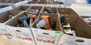 Boxes by the dozens are collected an sorted to make sure the right toy reaches the right child