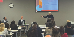 Illinois Supreme Court Chief Justice Theis gives closing remarks at the learning event and thanks Superintendent Mike Davis (seated immediately to her right) for leading a discussion on the lived experiences of detained youth. 