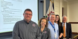 Members of KaneComm and County Board members Bill Roth and Bill Lenert 