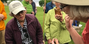 Kane County Certified Naturalist Sue Mikowski takes an up-close look at the keeled scales of a water snake during a KCCN field trip.