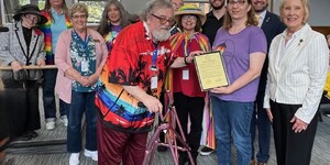Kane County Board member Michael Linder presents the 2025 Pride Month proclamation to Gwyn Ciesla, President of Aurora Pride