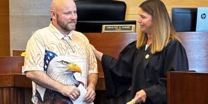Robert Lundquist with Judge Christine Downs during Veterans Treatment Court graduation 